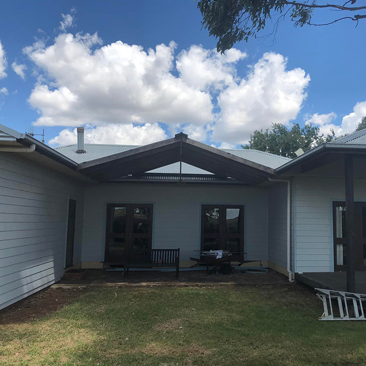 After: gabled roof over the courtyard of a weatherboard house